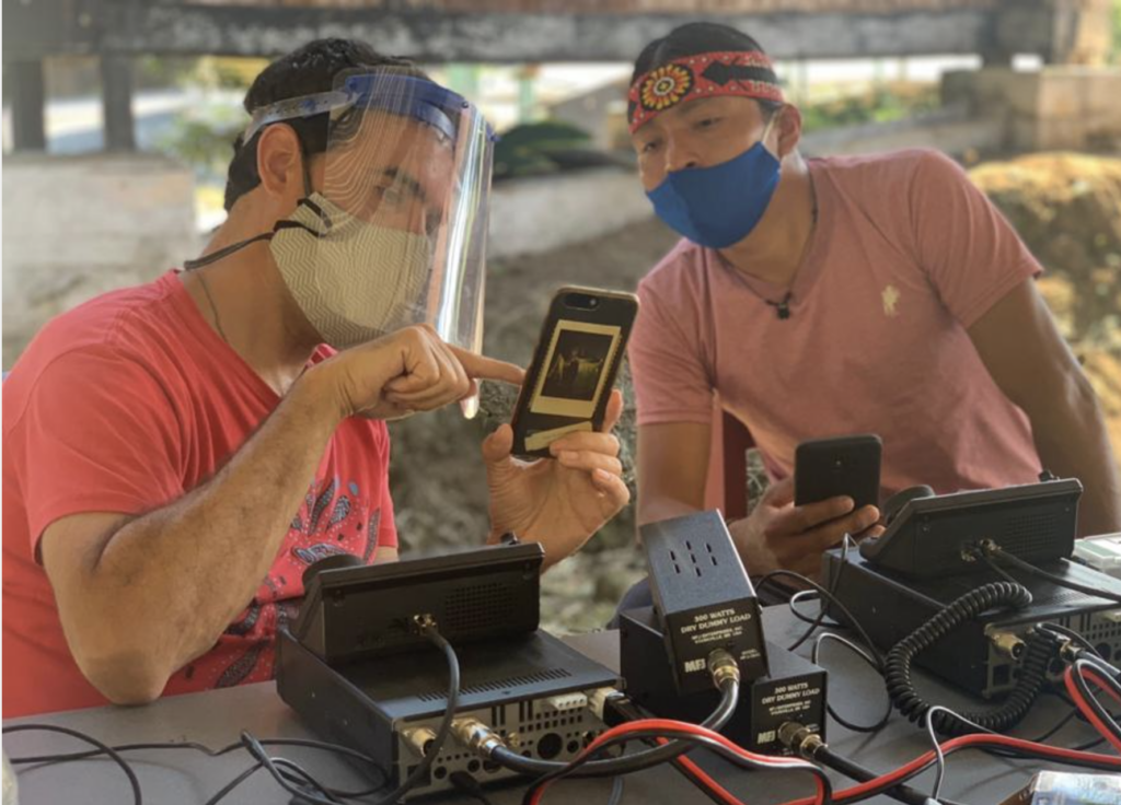 Peter Bloom, Rhizomatica founder, showing Nantu Canelos, an Achuar indigenous technician in Ecuador, how the High-Frequency Emergency and Rural Multimedia Exchange System (HERMES) works