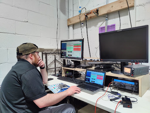 A member of the Boston Amateur Radio Club (BARC) working at their new operating station.