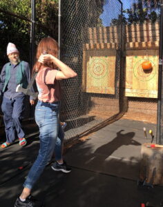 Grants Manager Chelsea Párraga, KF0FVJ, giving tips on axe throwing to Board member John Gilmore, W0GNU