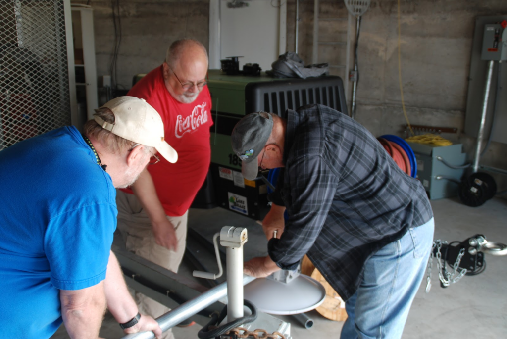 Chip Eckardt, KD9OQI, Chippewa Valley Amateur Radio Club (CVARC) Treasurer, watching John Lindberg, AA9JL, CVARC President, mount a dish to a post at the Lake Hallie Water Tower