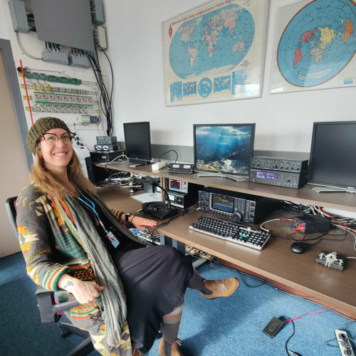 Rosy Schechter, KJ7RYV, sitting at a radio station at the International Telecommunication Union (ITU)