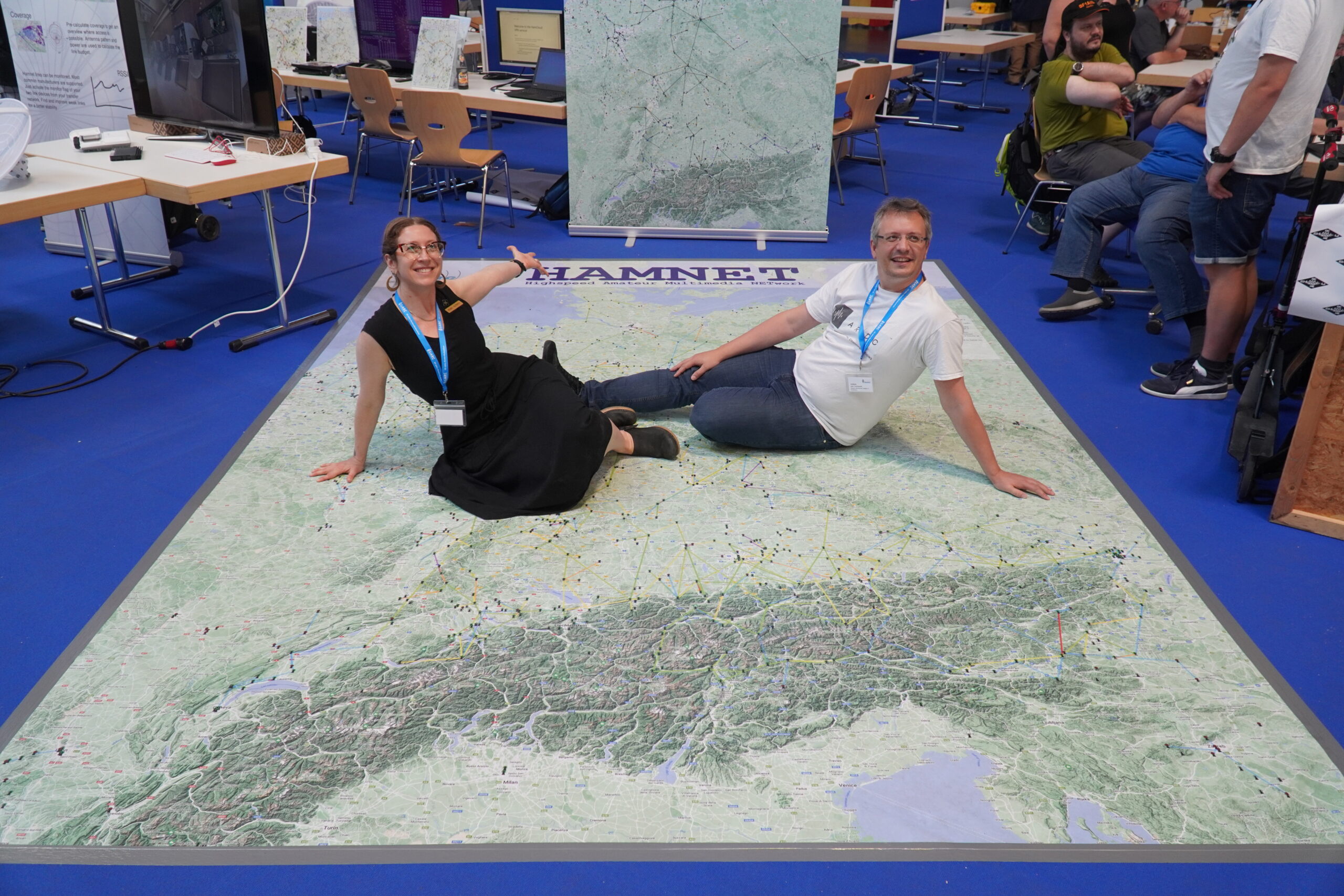 Rosy Schechter (KJ7RYV) with Jann Traschewski (DG8NGN) on a floor map of HAMNET, currently the largest network utilizing 44Net