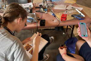 Youth on the Air (YOTA) Camp 2022 attendees building attenuator kits to be used for fox hunting